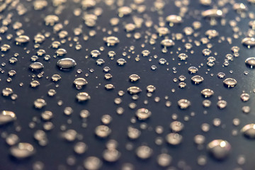 Water drops on a shiny surface, selective focus. Rain drops. Abstract background.
