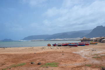 Fototapeta na wymiar Boats with sugar sack sails stranded on the beach sand on Sao Vicente Island in Cape Verde