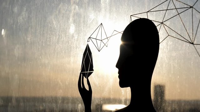 Not real black silhouette of a woman on the glass window and thw sunset sky on the background. Stock footage. Dark sticker on the high rise building in a shape of a woman.