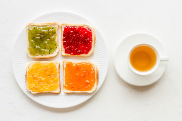 Tea party with jam. Toast, teapot, cup on white background frame copy space