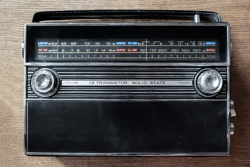 Fototapeta premium Wireless technology. An old radio on wooden background. Radio broadcasting. Musical record. Fm radio.