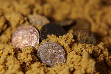 Old Magnus Ducatus Lithuaniae coins in the sand