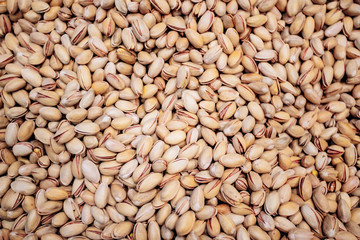 Background make from salt pistachios in a shell. A lot of pistachio nuts