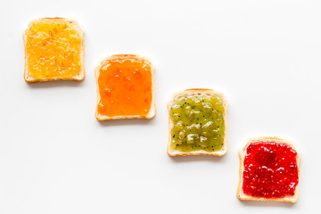 Toast with jam. Colorful set on white background top-down copy space