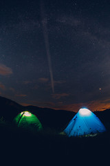 Tents in the night with the milky way.  Wanderlust and travel concept. 