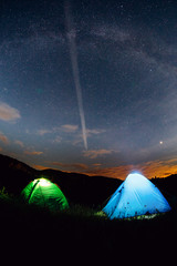 Tents in the night with the milky way.  Wanderlust and travel concept. 