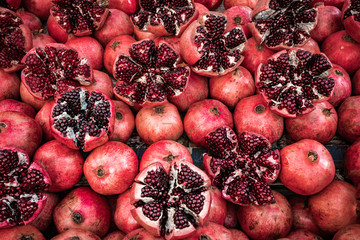 Red pomegranate fruit at street market. Group of pomegranates