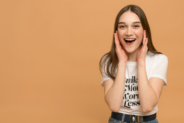 Close-up portrait of nice attractive lovely pretty cheerful cheery amazed straight-haired girl surprised expressing positive emotion isolated on bright orange background