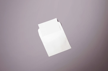 White envelope and post card on background. Top view blank envelope mockup and blank letterhead...