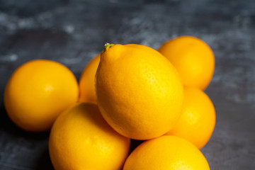 Fresh ripe lemons on the rustic background. Selective focus. Shallow depth of field.