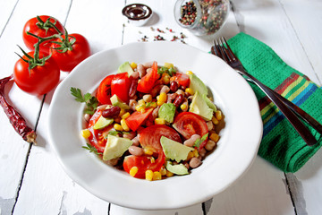 Mexican-style vegetable salad with beans, avocado, tomatoes, corn, and chickpeas