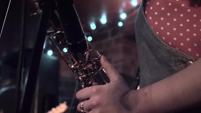 Musician playing on a saxophone. Closeup on a saxophone