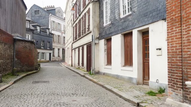HONFLEUR, FRANCE - APRIL 08, 2018: view of empty beautiful street with old traditional houses at the center of Honfleur, Normandy, France