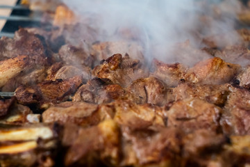 Shish kebab roasting on the grill, selective focus. Barbeque party.