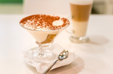 Tiramisu in a glass sprinkled with cocoa, trace from a spoon