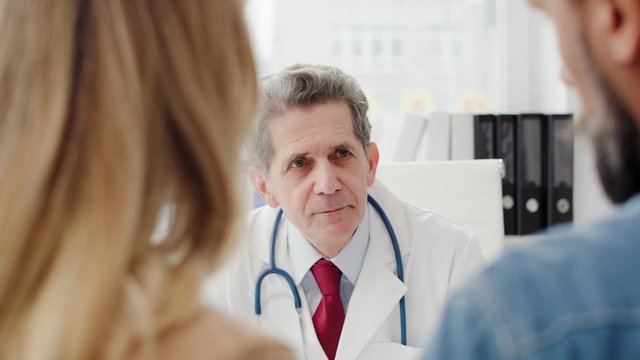 Mature doctor consulting prognosis with patients. Shot with RED helium camera in 8K 