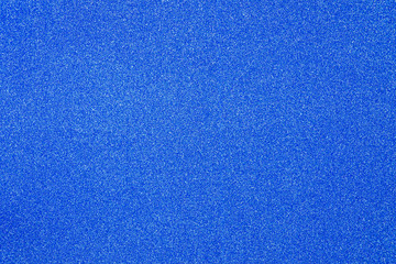 Blue giltter texture abstract background. Shiny wrapper paper.