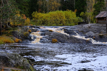 Little waterfall with brown water. Ruskeala waterfalls, Karelia, Russia.