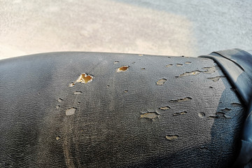 Artificial leather black broken pattern texture ,Black motorcycle old seats torn.