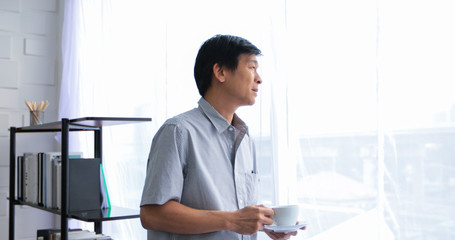 Senior Asian man drinking coffee on relaxing time