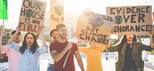 Group of demonstrators on road, young people from different culture and race fight for climate change - Global warming and enviroment concept - Focus on center man face
