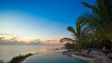 Indian Ocean coast line with palm trees and blue sky, Zanzibar, Tanzania