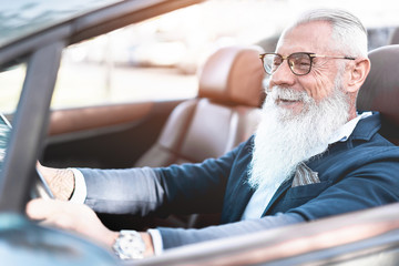 Hipster stylish man driving convertible car - Senior entrepreneur having fun with cabriolet auto - Fashion, elegant and business concept - Focus on face - obrazy, fototapety, plakaty