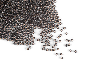 Brown scattered beads on a white background, top view, costume jewelry
