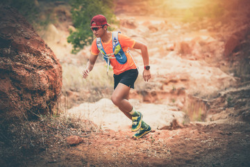 A man Runner of Trail and athlete's feet wearing sports shoes for trail running in the mountain