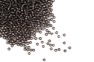 Naklejka premium Brown scattered beads on a white background, top view, costume jewelry
