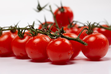 Ripe cherry tomatoes isolated on white background