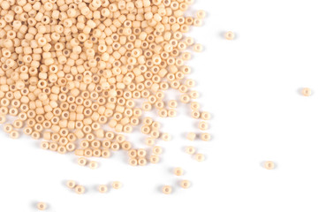 Orange beads scattered beads on a white background, top view, costume jewelry