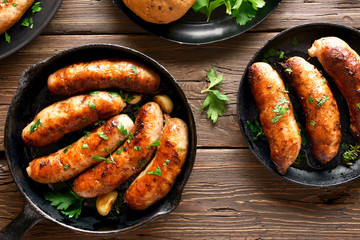 Roasted sausages in frying pan - obrazy, fototapety, plakaty