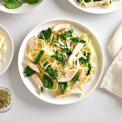 Spaghetti with spinach leaves, grilled chicken breast and cheese