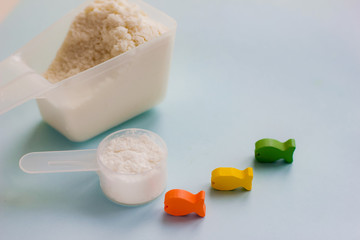 Fish collagen concept. collagen capsules and collagen peptides powder with fish on blue background. copyspace for text. Beauty and spa concept