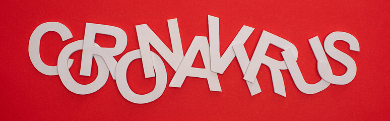 Top view of coronavirus lettering on red background, panoramic shot