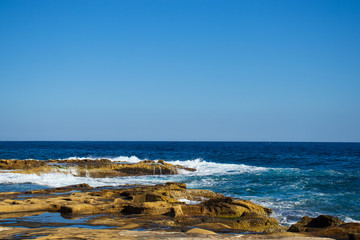 Fototapeta na wymiar salt rocks coastline and beautiful blue sea scenery
