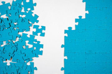 Undone puzzle jigsaw. Blue puzzle on white background.