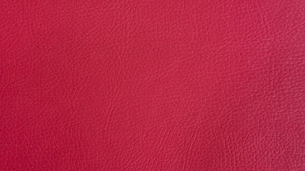 Carmine-crimson artificial or synthetic leather background with neat texture and copy space, colorful fabric sample with leather-like finish aimed for upholstery, fashion, sewing or footwear projects
