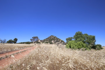 Pyramid Hill in Central Victoria, Australia surrounded by dry grass in summertime