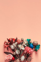 A vertical view of bright spring flowers bouquet and colorful easter eggs with copy space on the top of the stock image. View from above. Happy Easter, springtime concepts