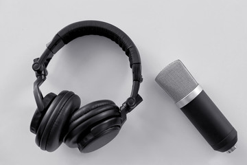technology, sound recording and audio equipment concept - headphones and microphone on white...