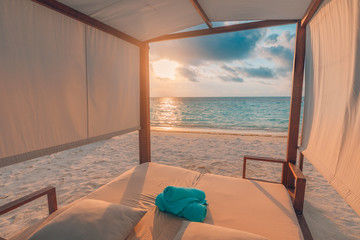 Sunset luxury beach canopy at tropical resort and spa for vacation. Wonderful scenery, white sand, sunset sky and relaxing mood. Perfect summer holiday, beach landscape, inspirational travel concept