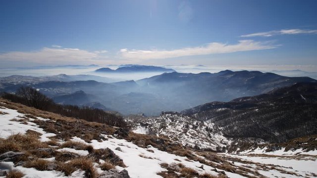 mountain range of the Campania Apennines with snow and mist seen from Matese mount. Matese National Park, Campania and Molise, Italy