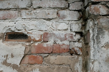 Old damaged brick wall with plaster background texture.