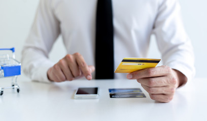 Businessman use mobile phones to register for security Online with a credit card to buy products online through application,Online shopping or Internet technology concept.