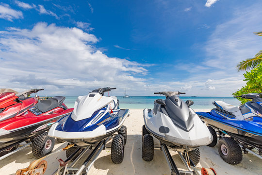 Colorful Jet skis on the beach. Tropical beach with water sport equipment