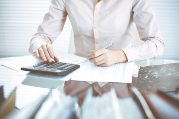 Bookkeeper woman or financial inspector making report, calculating or checking balance, close-up....