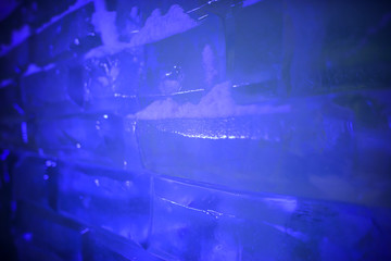 Fototapeta na wymiar Ice bricks backlit in blue as a background