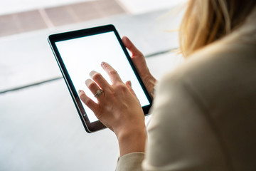 Young women typing on digital tablet